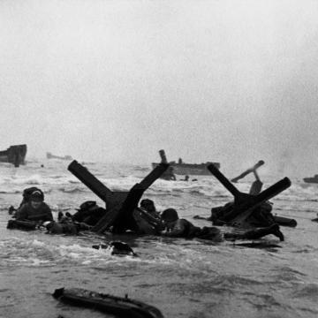 Soldiers taking cover on the beach